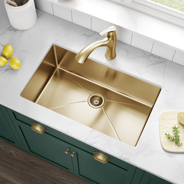A gold faucet and kitchen sink add to the kitchen's charm, complemented by a green cabinet.