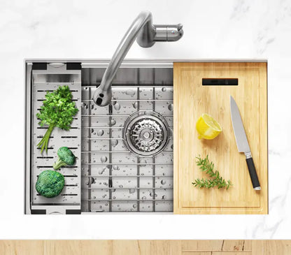 Broccoli and a lemon, accompanied by a knife, are placed on a bamboo cutting board situated on a kitchen workstation.