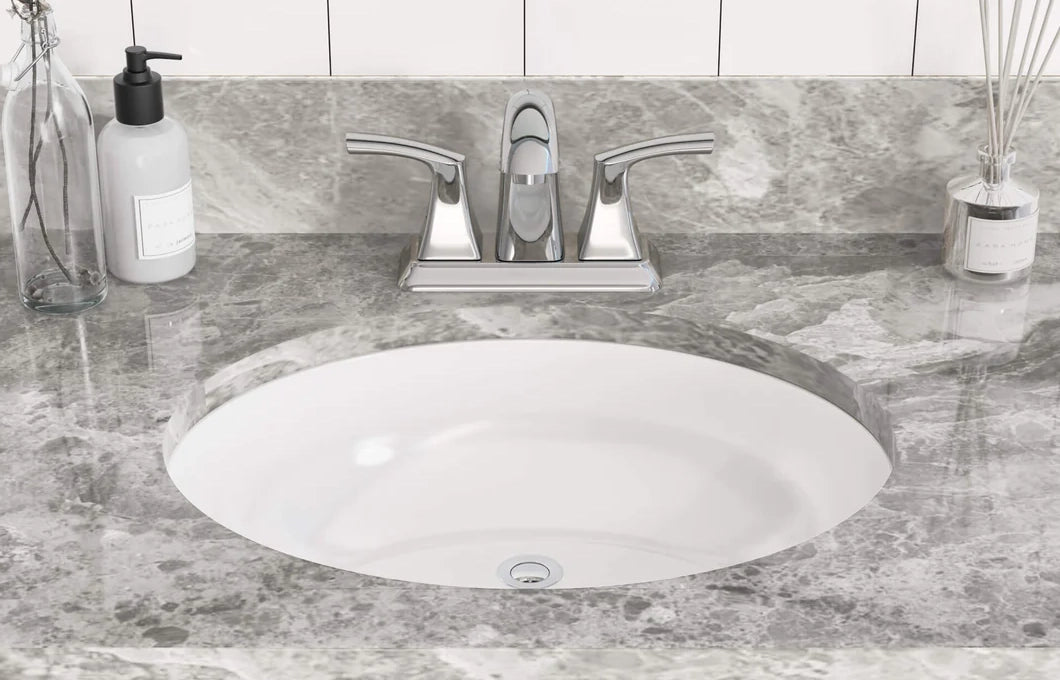 A bathroom sink and a two-handle faucet are mounted on elegant marble.
