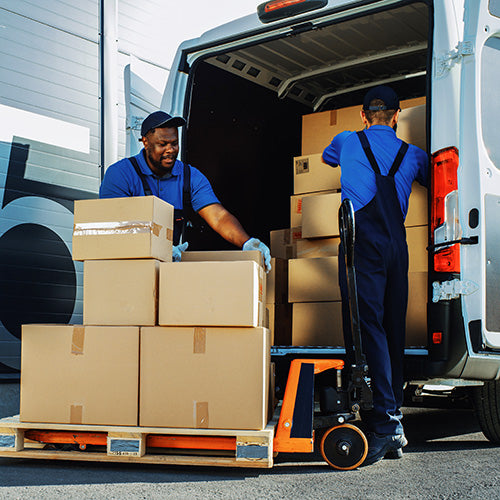 Logistics personnel are loading shipments onto the truck for delivery.