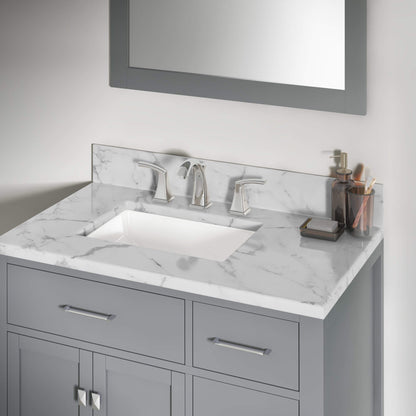 A two-handle bathroom faucet with an undermount white sink is beautifully complemented by marble granite